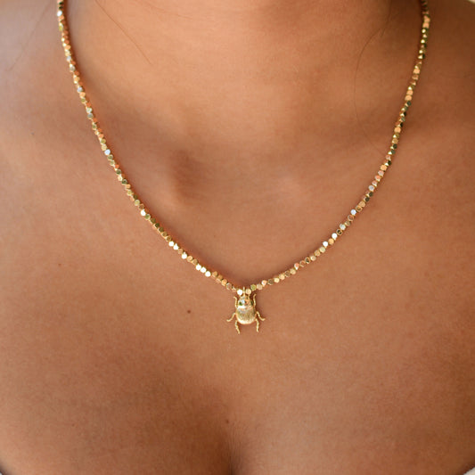 collier en pierres semi précieuses d'hématite plaquées or orné d'un charm scarabée 