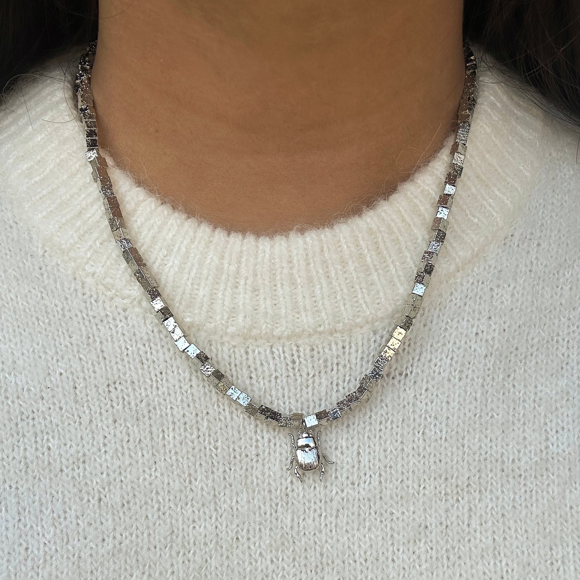 Collier en pierres volcaniques plaquées argent orné d'un charm scarabée porte-bonheur